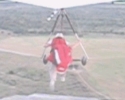 A hang glider pilot launches from a 425 foot ridge.